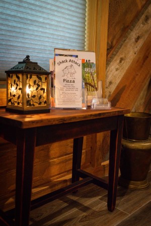 Table next to front door with local menus and brochures.