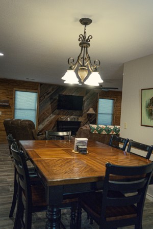 Large 6-person dining table next to the kitchen looking in to the living room