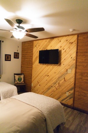 Samsung flat screen smart TV on the wooden accent wall of the dual Twin XL bedroom