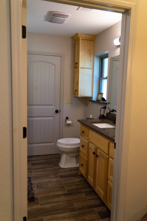 Bathroom #2 with tub shower combo, granite counter tops, wood accents