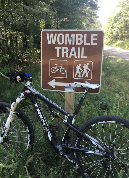 Trek MTB Parked Next to the Womble Trail Sign, Image Credit: Pinkbike.org